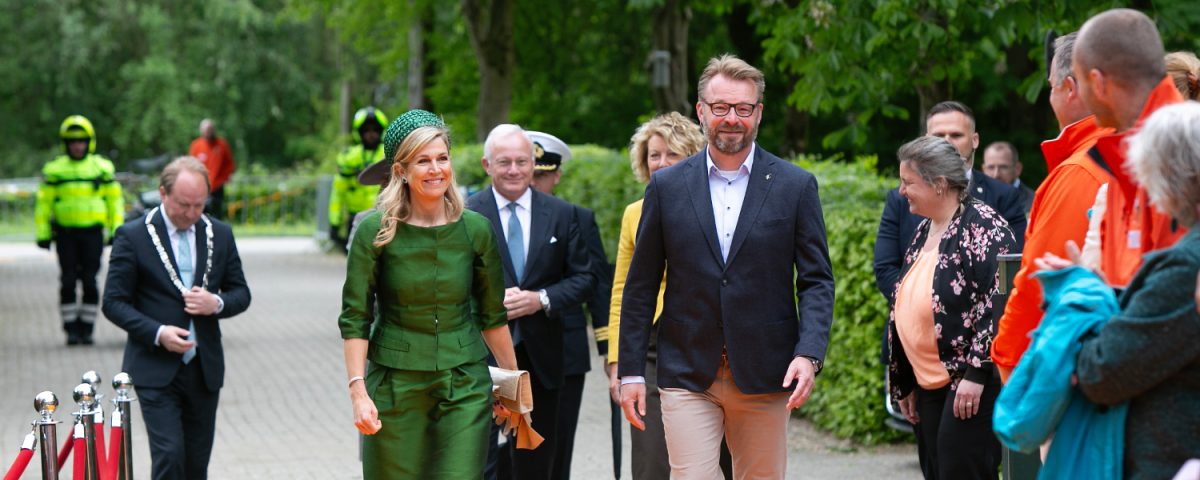 People walking on an orange carpet