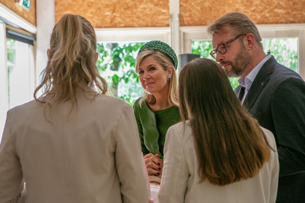People standing around a table, talking to each other