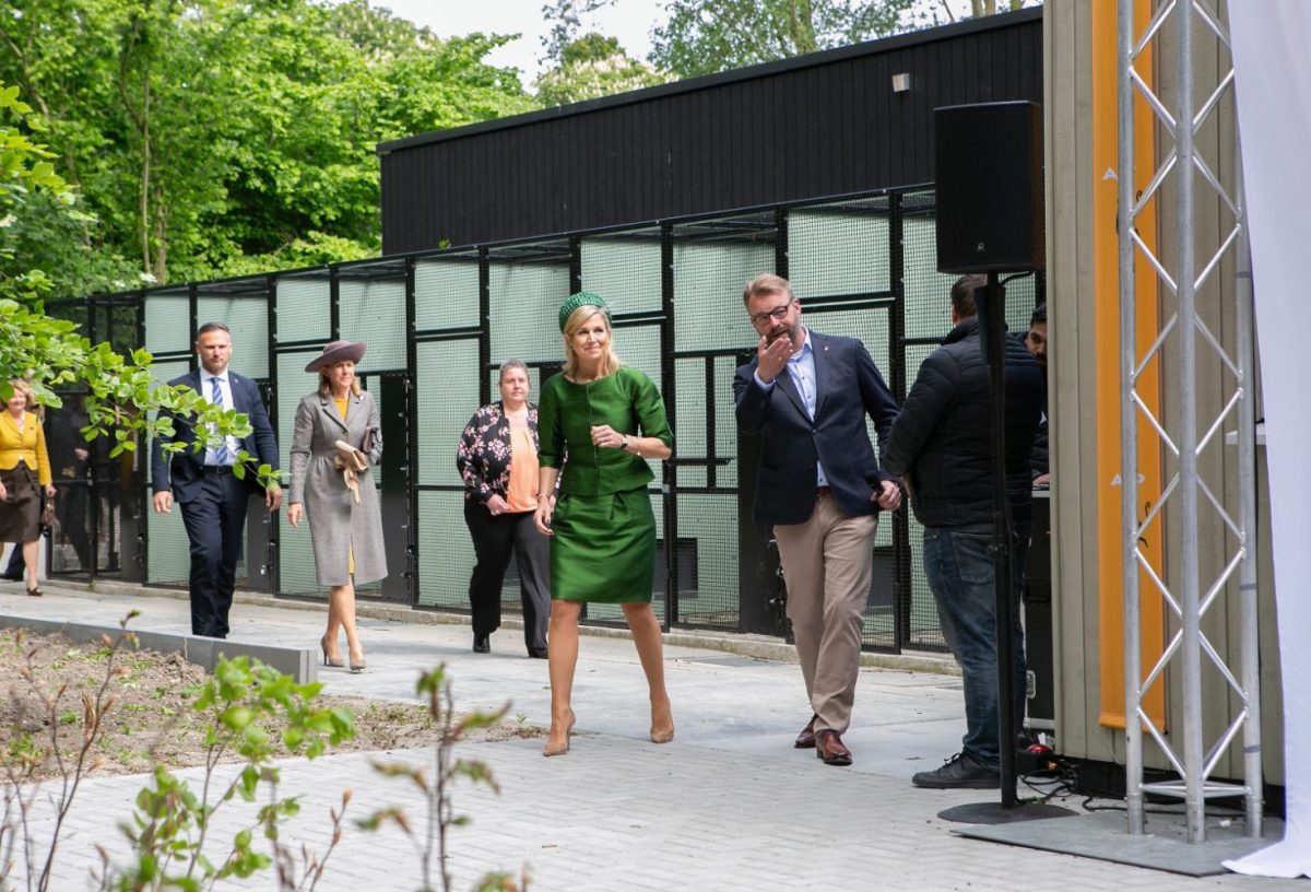 People walking alongside a building.